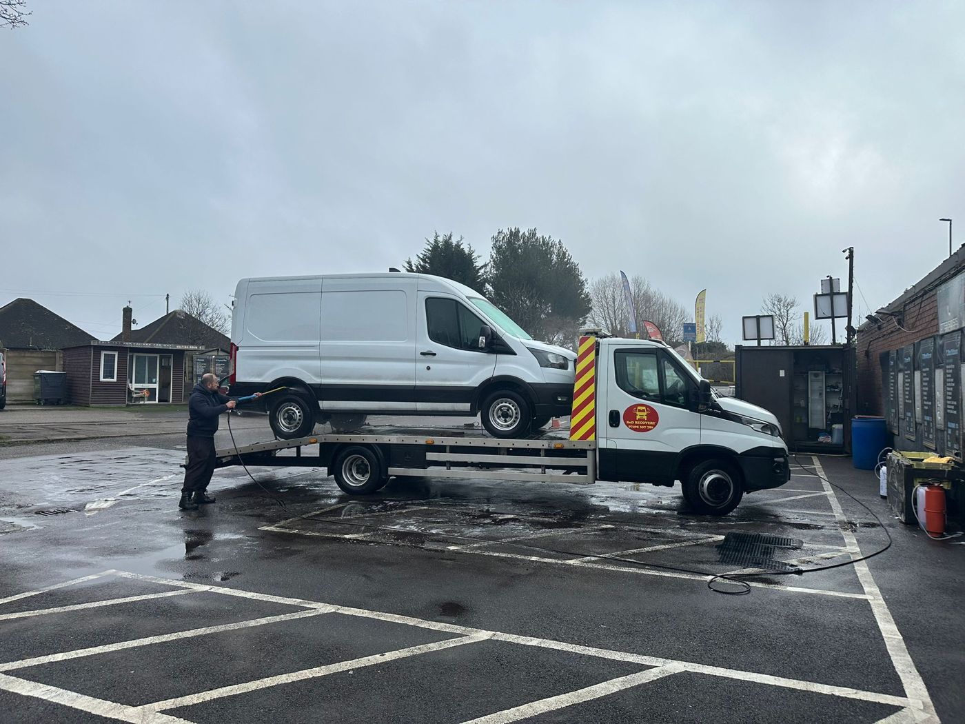 White Ford Transit van loaded on a BnD Recovery flatbed truck