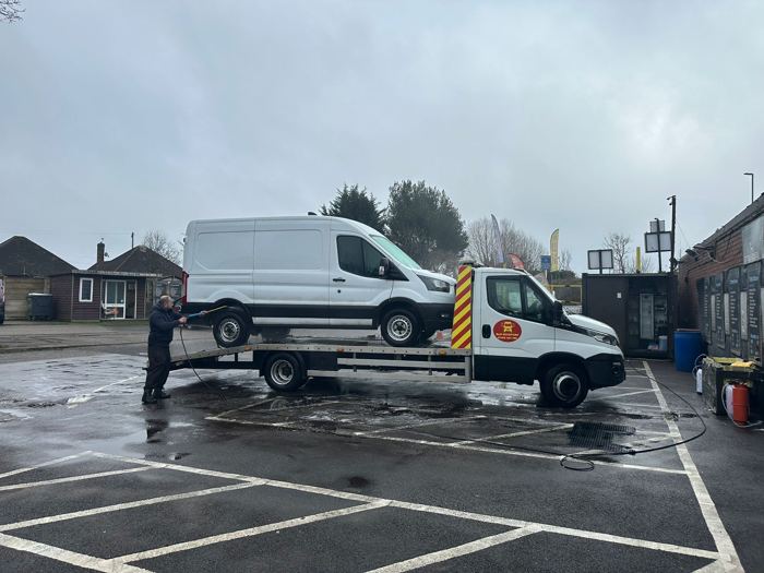 White Ford Transit van loaded on a BnD Recovery flatbed truck