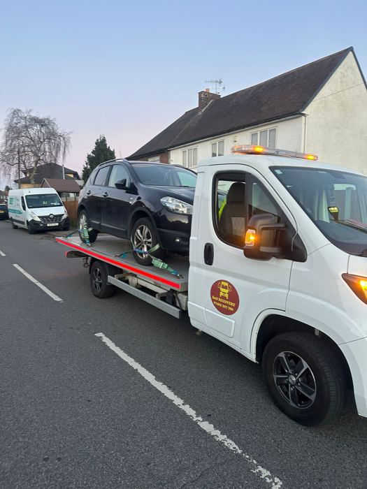 Black Nissan Qashqai recovered onto a BnD Recovery truck at dusk