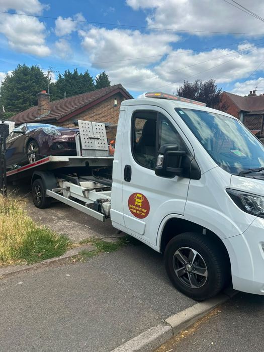 Burgundy Alfa Romeo collected from a home driveway on a BnD Recovery truck